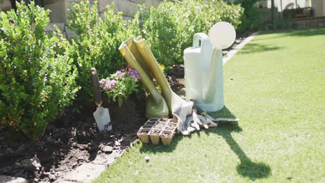 close up of garden equipment lying on grass on sunny day