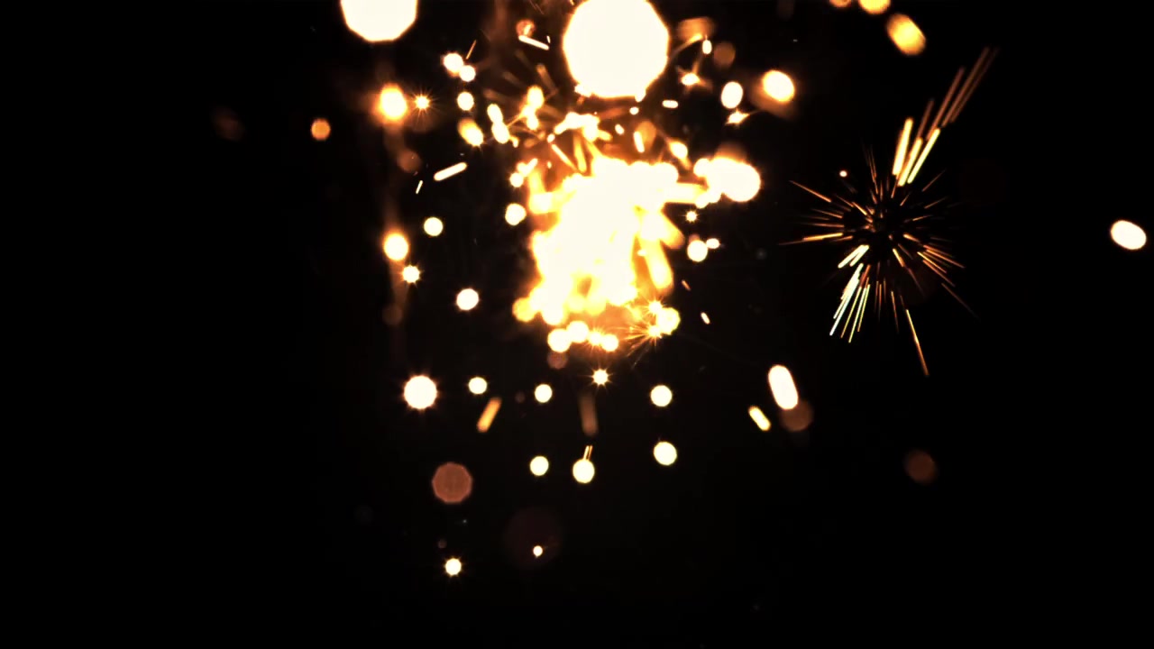 Scintille dorate e luci bokeh su sfondo nero