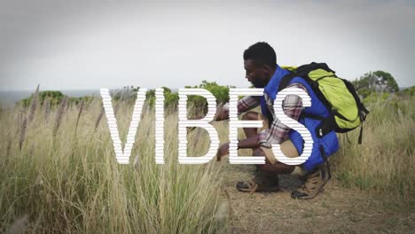 animation of the word vibes written in white over man hiking in mountains touching grass