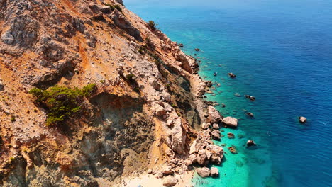 boats on turquoise beach. boats are docked near a sandy beach, surrounded by rocky cliffs and clear turquoise water on a sunny day