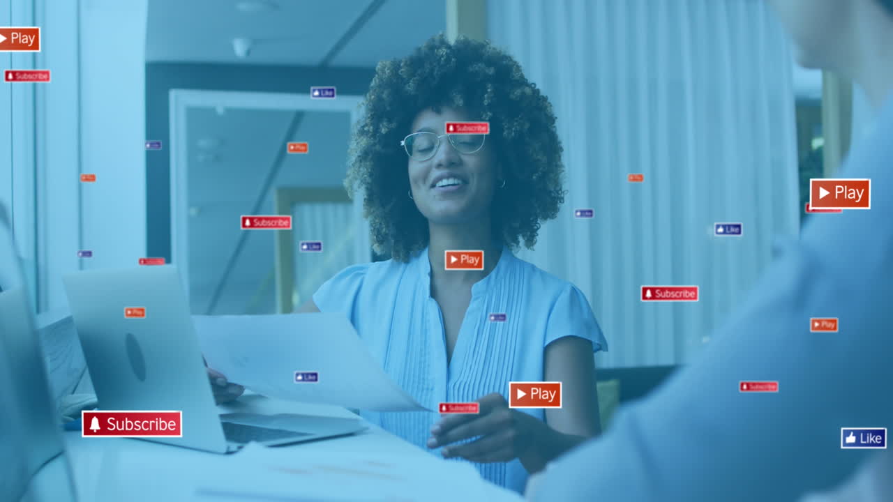 Animation of social media icons with texts over diverse business people having meeting at office