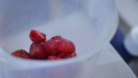 frozen strawberries in a plastic container