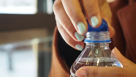 woman opening a water bottle