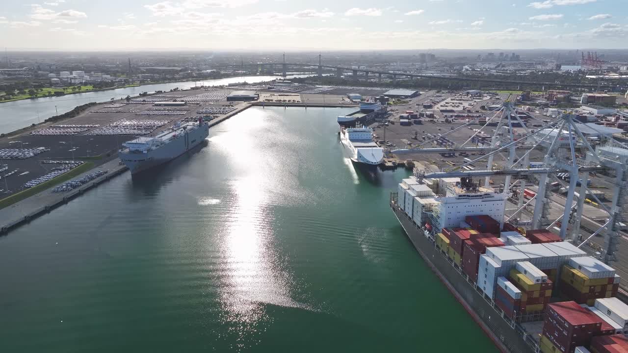 Freight terminal with cargo ships cranes and Westgate Bridge visible in Melbourne harbour