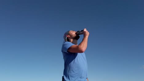 hiker drinking beer on peak at rocky mountain range reveal kananaskis alberta british columbia border canada