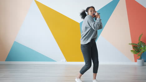 woman singing and dancing in a colorful room