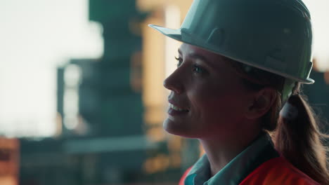 close-up of a female engineer in hard hat and safety vest