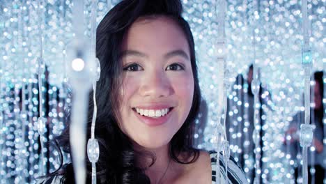 beautiful young asian filipina woman smiling in dynamic fairy lights in 4k slow motion