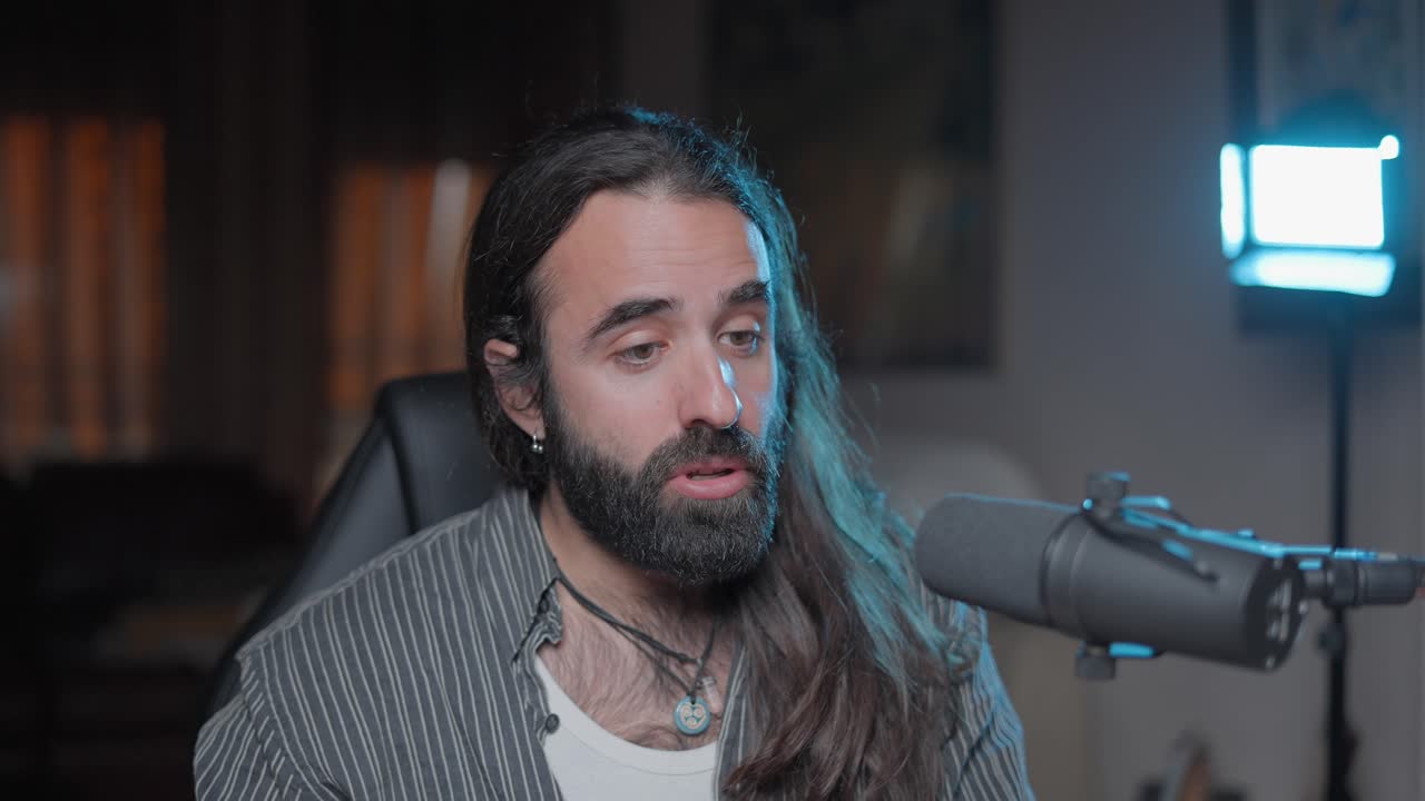 Man speaking into a microphone in a home podcast studio