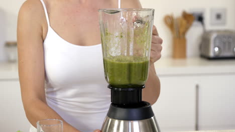 woman making a smoothie