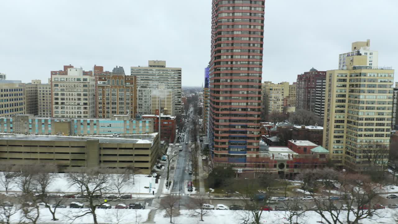 Aerial, Dolly Right with Parking Garage and High Rise Apartment Complex in Background on Cold Winter Day