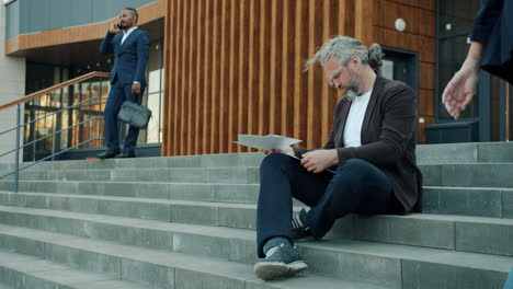 businessman reading documents outdoors