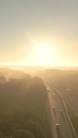 sunrise highway through misty countryside