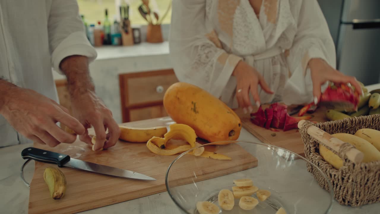 Couple preparing a tropical fruit salad