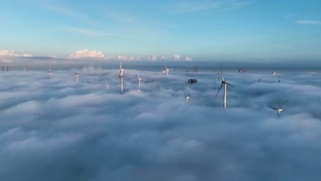 incredible aerial above cloud inversion - wind turbines turning at westerschelde