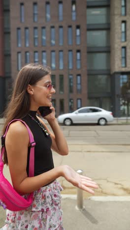 young woman talking on phone in the city