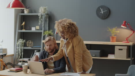 diverse male and female colleagues cooperating in office