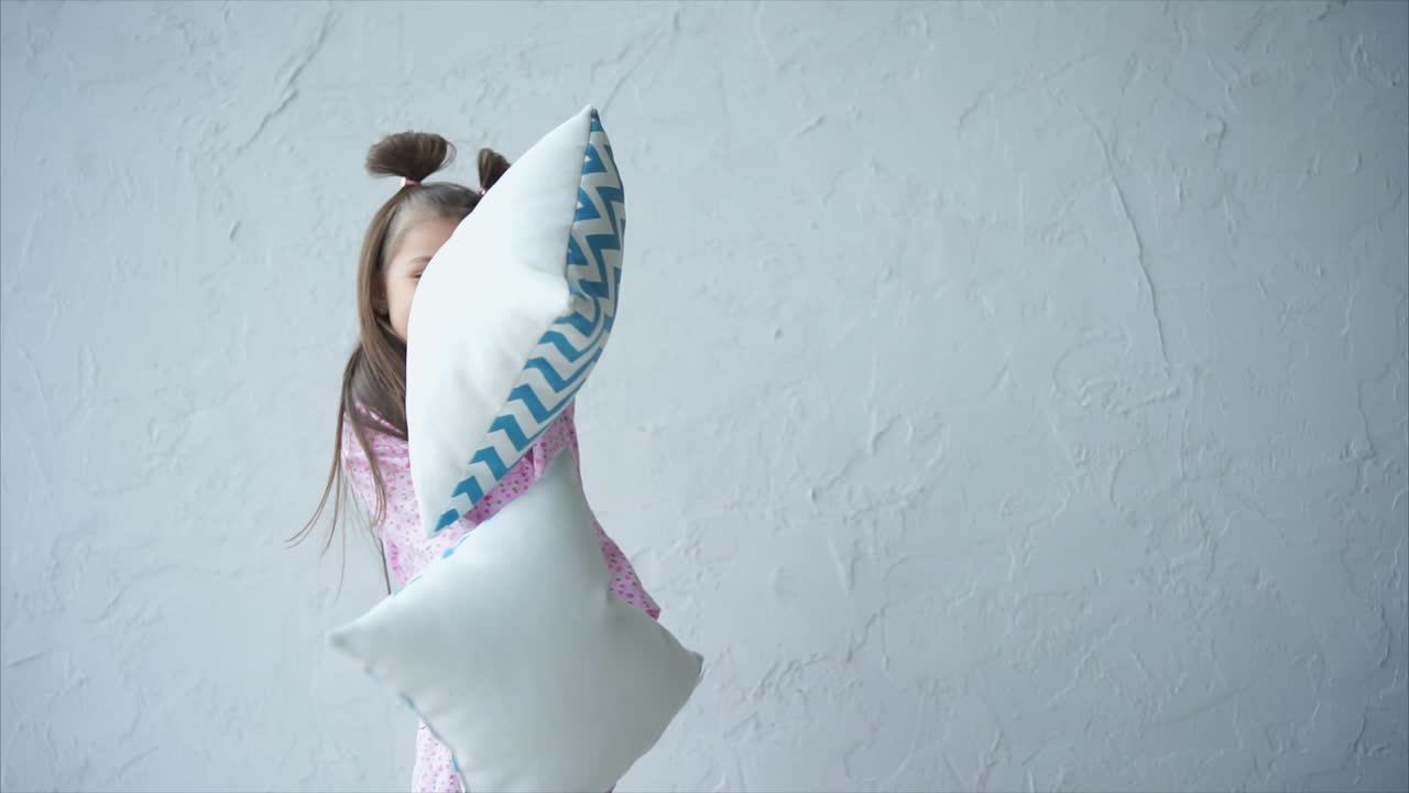 Happy Child Playing with Pillows