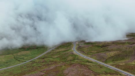 mountain pass shrouded by low lying clouds in east iceland