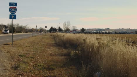 a street sign shows directions to interstate highway i25 in loveland colorado