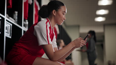 woman using phone in a locker room