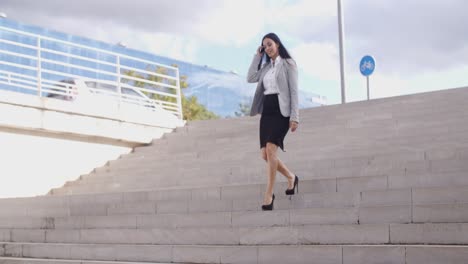 smiling woman walking down staircase