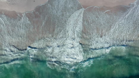 White-Frothy-Waves-Rolling-Onto-Sandy-Shore-Of-Blouberg-Sea-In-Cape-Town,-South-Africa