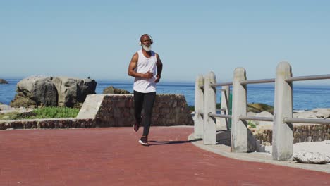 senior african american man exercising running on road by the sea