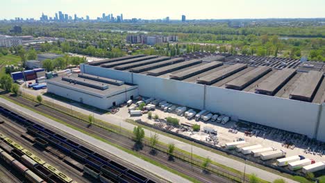 Flying-above-industrial-railroad-station-with-cargo-trains-and-freight-containers