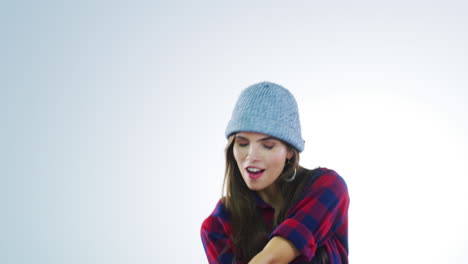 woman in plaid shirt and knit hat