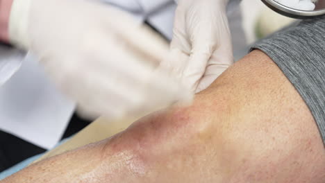 plasma concentration is injected to an injured knee to accelerate the healing of damaged tendons, ligaments, muscles, bones and joints. close up. prp therapy in hospital.