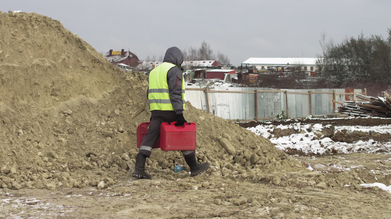 Construction Site in Winter with Worker