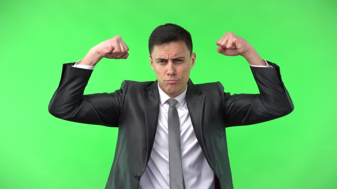 Businessman Flexing Muscles Playfully on Green Screen