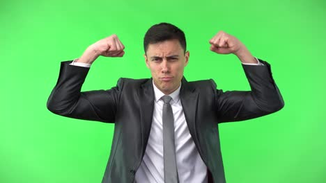 businessman flexing muscles playfully on green screen