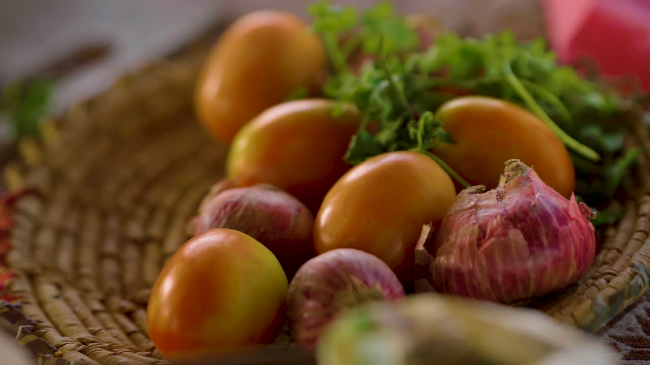 Fresh Tomatoes Red Onions and Green Herbs on Woven Tray for Cooking Ingredients and Healthy Eating in Tharparkar Sindh Pakistan Cuisine