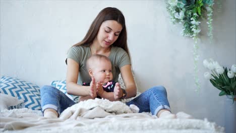 Mother and Baby Playing on Bed