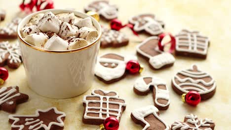 cup of hot chocolate and christmas shaped gingerbread cookies