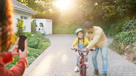 happy family, parents and teaching kid on bicycle