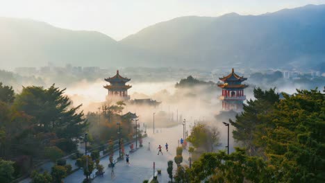 traditional chinese pagodas in misty morning landscape