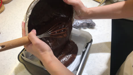 pouring chocolate on block for making brownies