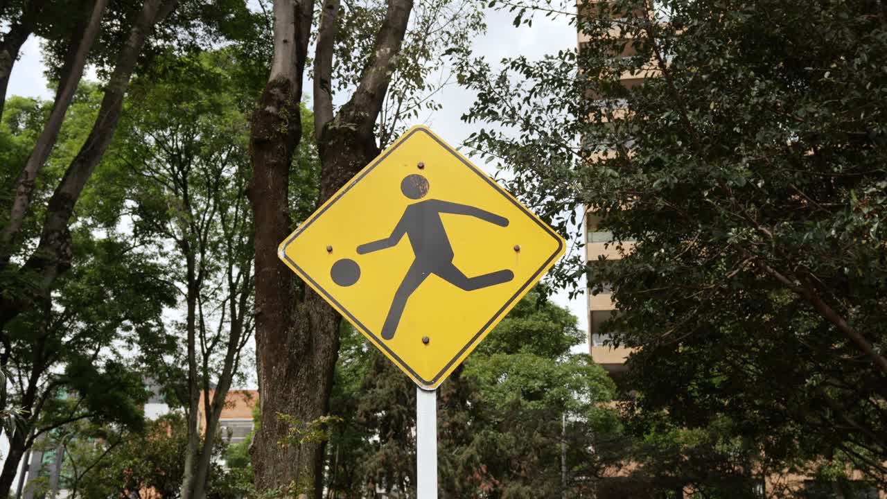 Warning traffic sign indicating a play area children crossing, yellow background