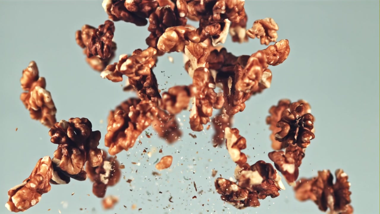 Peeled Walnuts Floating in Slow Motion