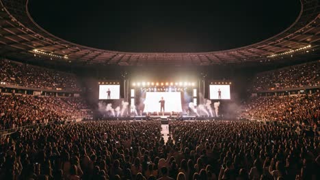 a mesmerizing live concert experience captured from start to finish, showcasing an electrifying performance on stage with thousands of enthusiastic fans cheering under the vibrant lights