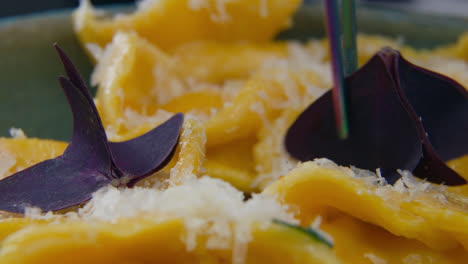 chef makes presentation of tasty ravioli dish