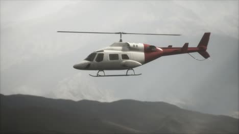 extreme slow motion flying helicopter near mountains with fog