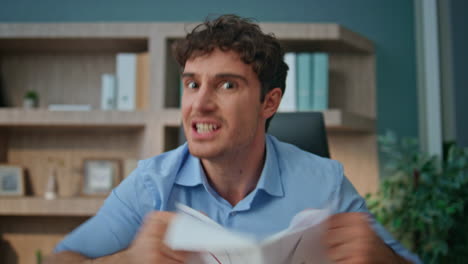 nervous boss calling web camera closeup. mad emotional man throwing graph papers
