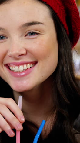 woman having a drink with a straw