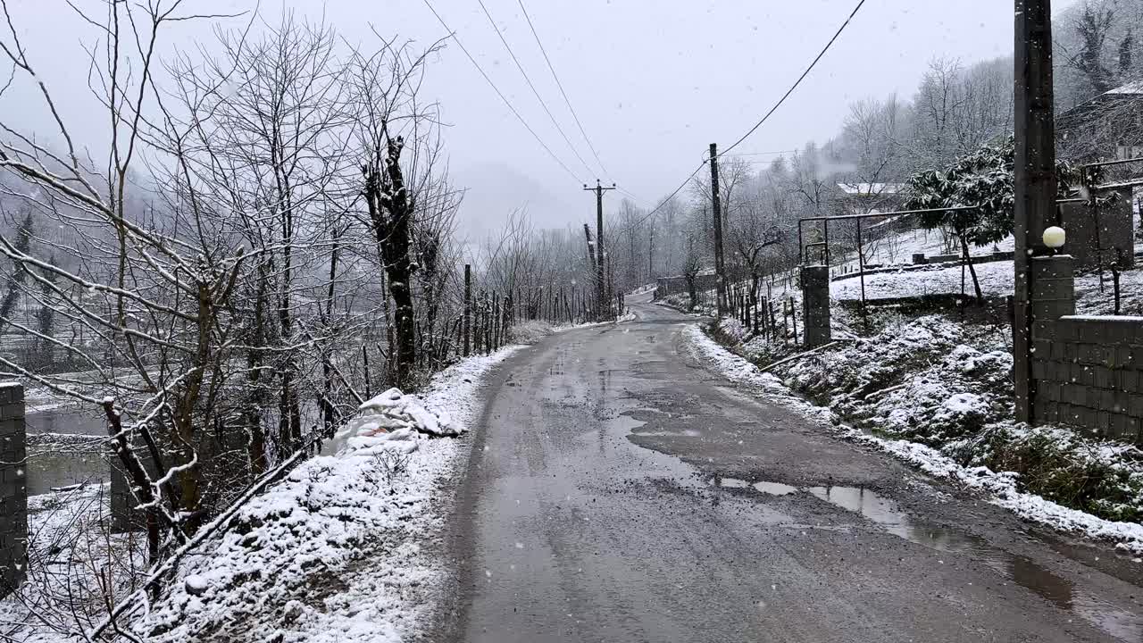 Empty road in gravel rural village winter snow heavy fall in mountain cabin in countryside Iran Hyrcanian wide landscape freezing nature farm wooden cottage livestock people driving lifestyle in woods