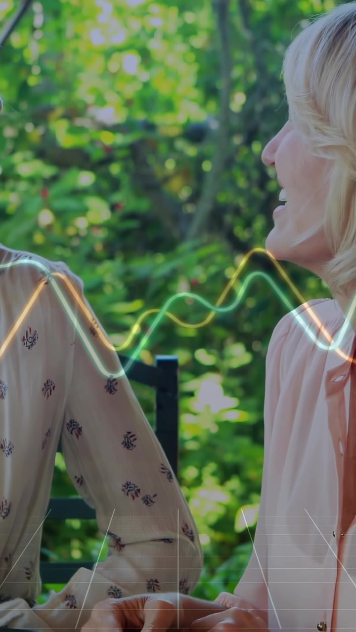 Vertical video: Two women reaching, holding hand, lifting cup for wellness with waveform over hands