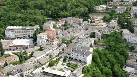 drone view in albania flying in gjirokaster over a medieval town showing the brick brown roof houses